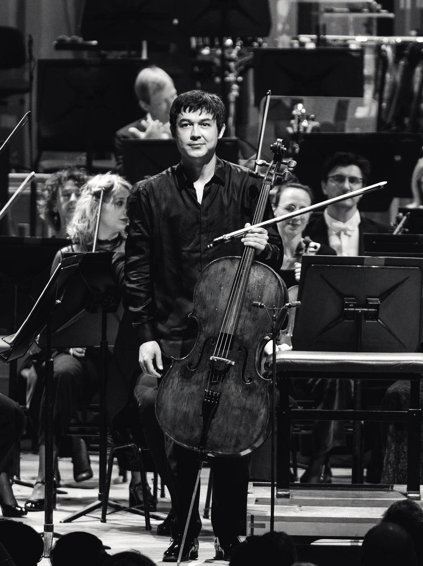 Portrait of Dilshod Narzillaev seated with his cello